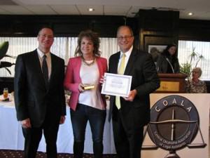Lisa McAlister accepts the COALA 2015 Paralegal of the Year award from Judges Richard Ogden and Don Andrews.