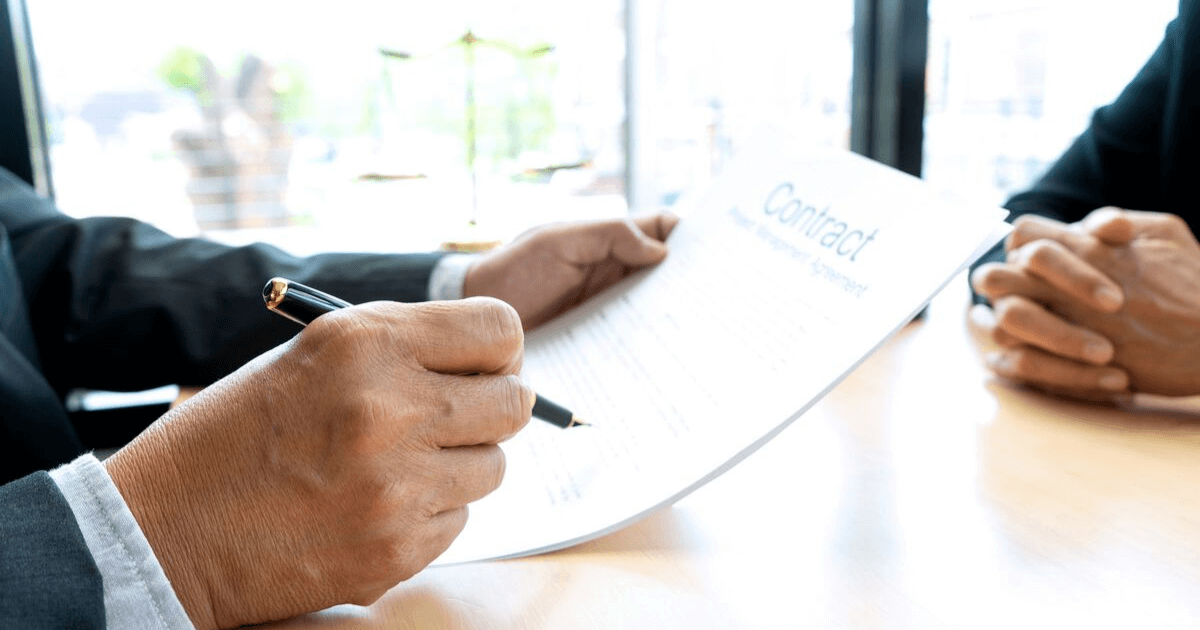 An employee looks over the employment contract that contains mandatory arbitration agreements