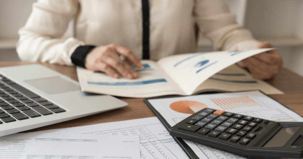 A woman works on her business audit, which is partially made easier by the Bipartisan Budget Act of 2015