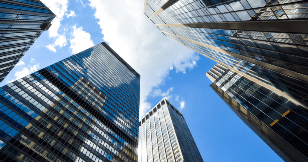 Various banking and bankruptcy law skyscrapers are shown from the perspective of looking up from the street