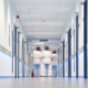 Two nurses walk down a hallway of a medical facility built with the proper Certificate of Need