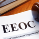 EEOC is shown in large letters on a pending lawsuit as a gavel rests on top of the paperwork