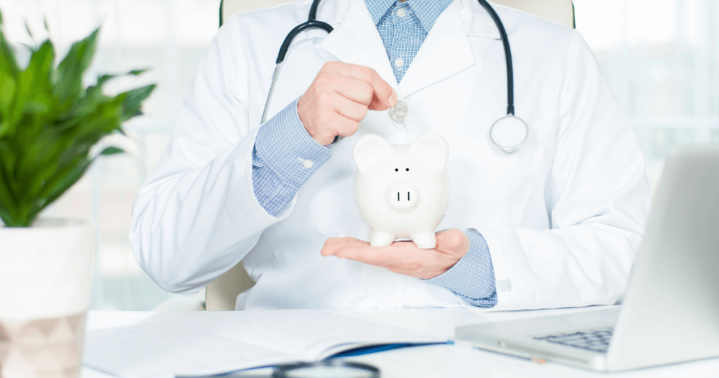 A doctors puts money into a piggy jar as he saves for his investment into his medical practice partnership.