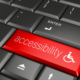 A keyboard is shown with an accessibility button instead of a return button, signifying that business websites need to be ADA accessible.