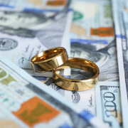 Image of wedding rings on money
