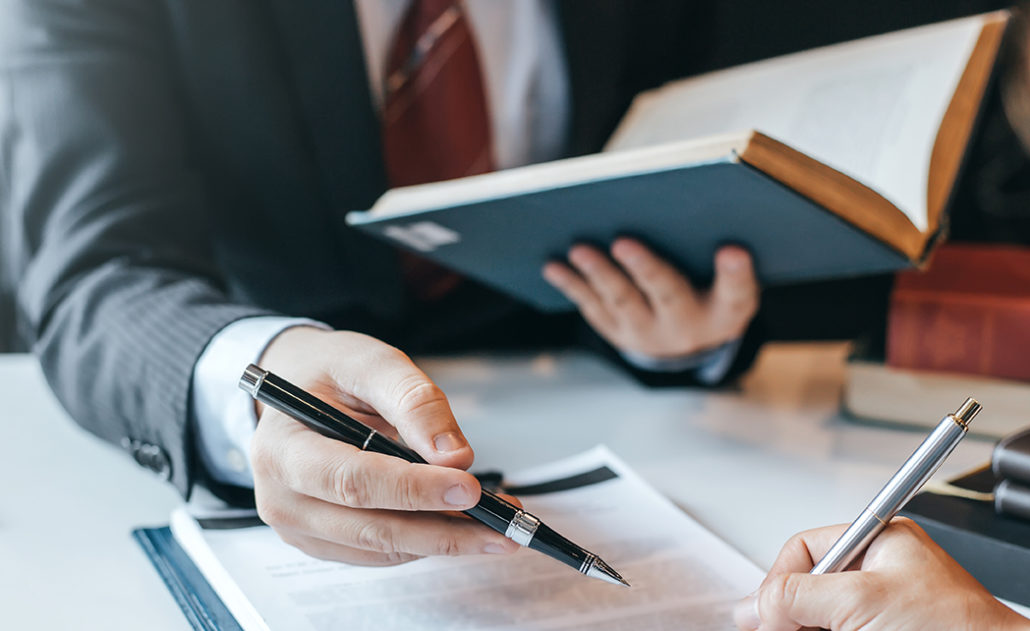 Businessman and lawyer discuss the contract document