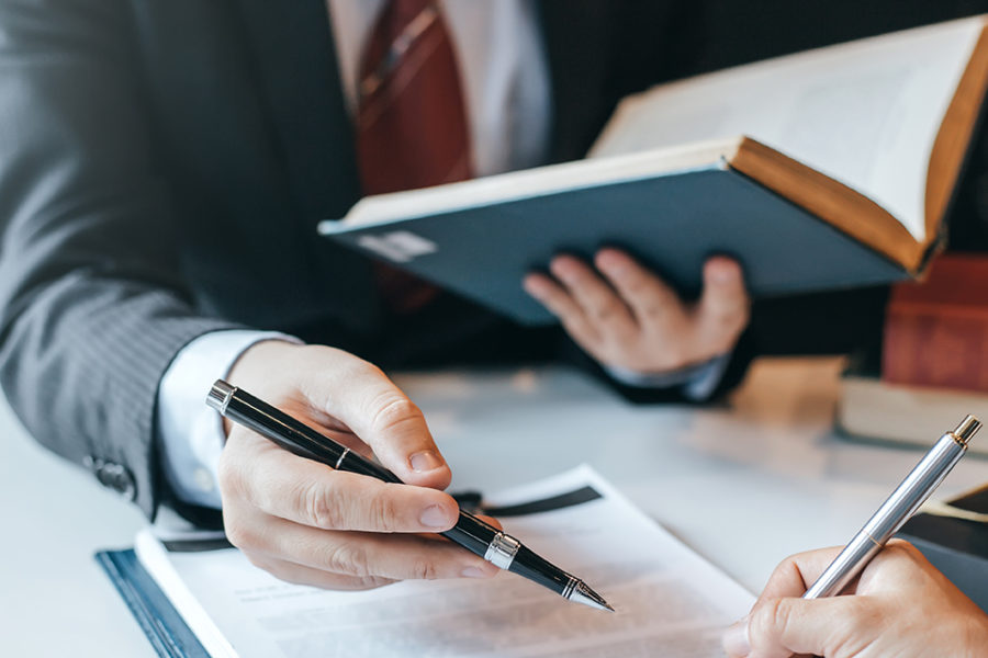 Businessman and lawyer discuss the contract document