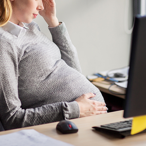 pregnant businesswoman at work stock img