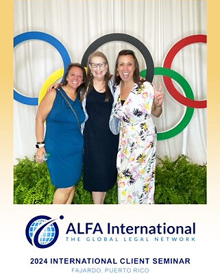 Three women pose for a photo at a conference