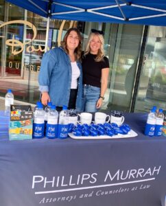 two women lawyers behind exhibition table