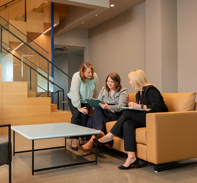 Phillips Murrah attorneys in a group reading one document