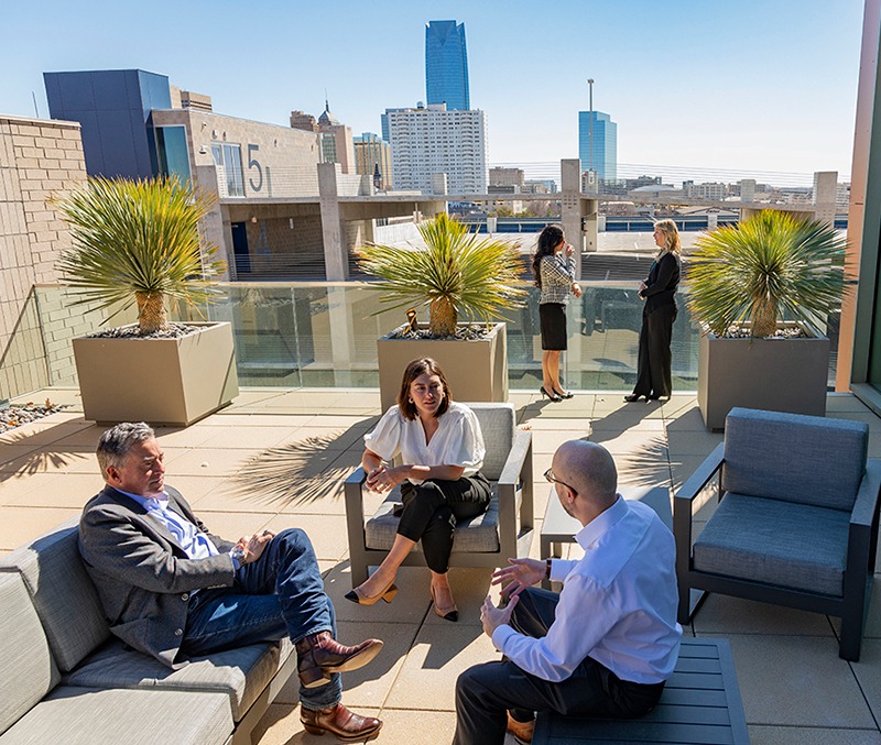 Phillips Murrah attorneys sitting in a group on a patio