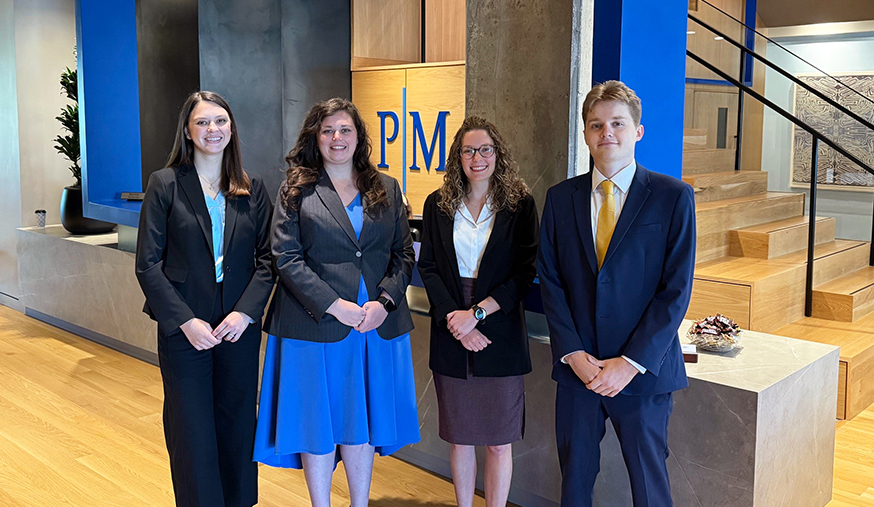 four phillips murrah summer associates posing together in the law fir's reception area.