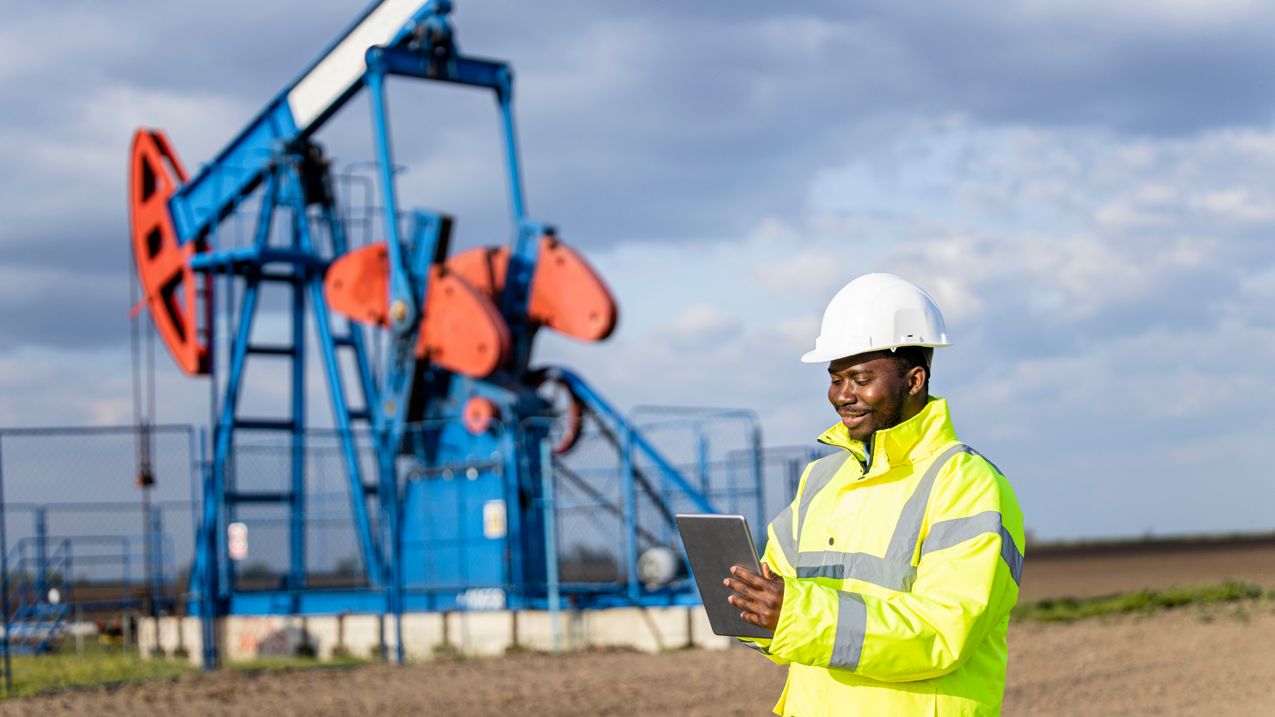 oil field worker checking oil field equipment