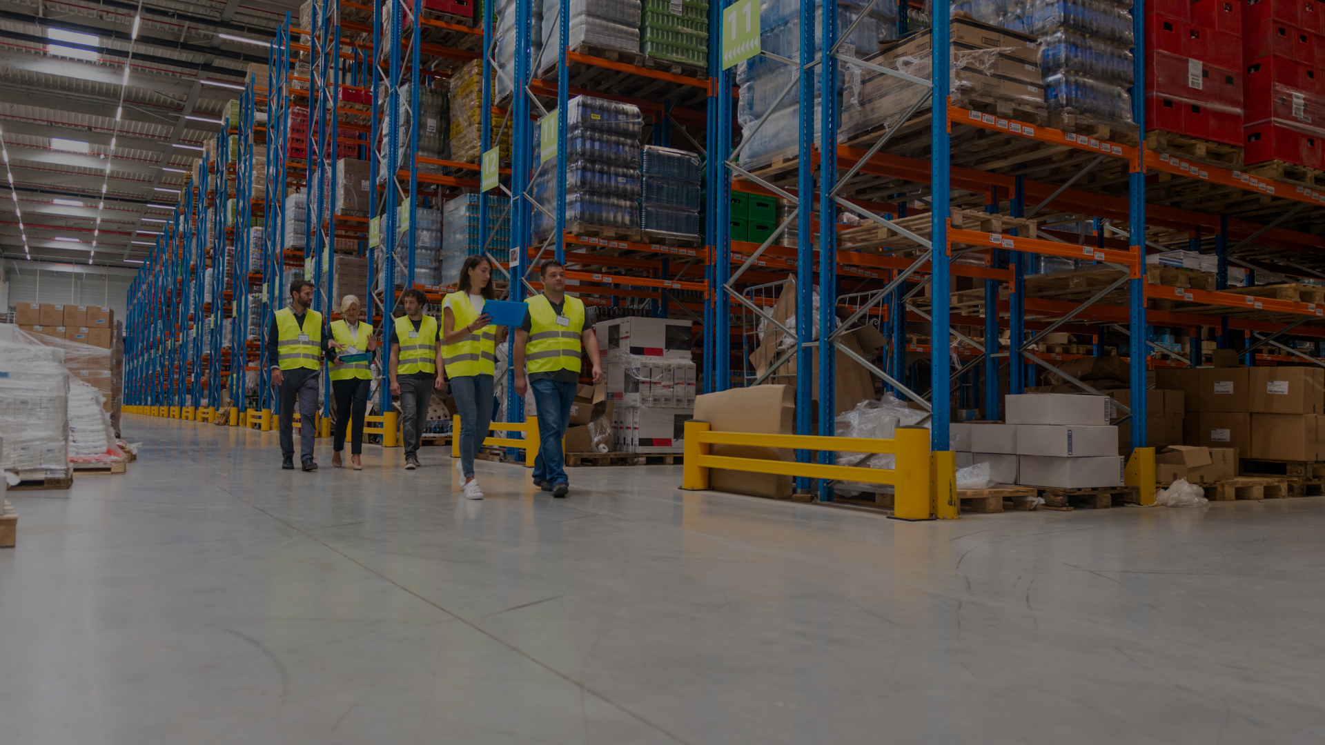 warehouse of products and employees awaiting to unload the crates.
