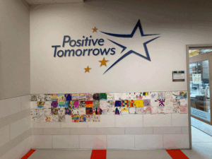 facility logo adorns a wall
